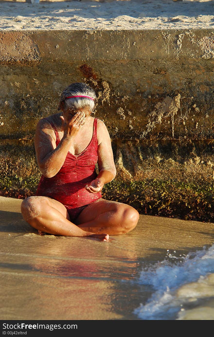 Lady sitting on the beach. Lady sitting on the beach