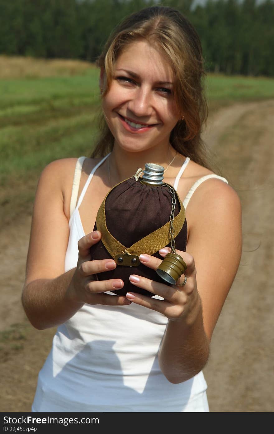 The girl quench thirst with flask in the outdoor