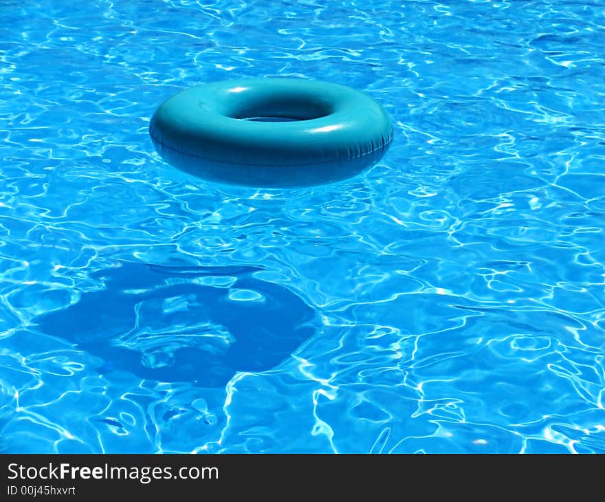 Inflatable tube reflecting in crisp, clear blue water. Inflatable tube reflecting in crisp, clear blue water