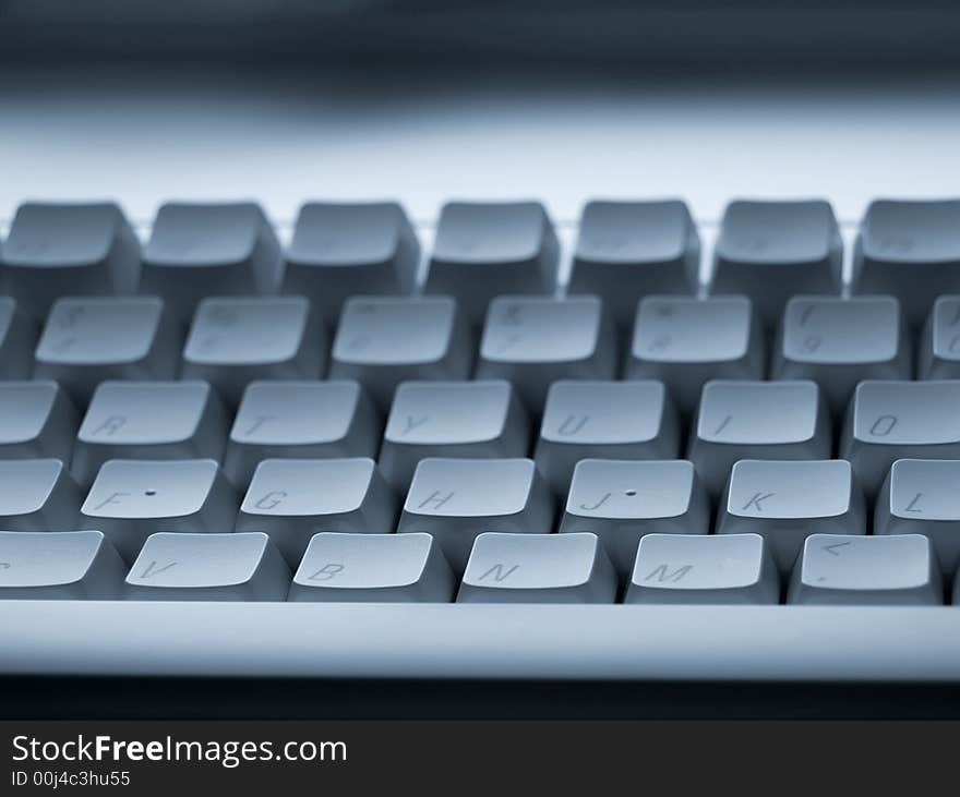 Focussed on front rows of computer keyboard with blurred background. Focussed on front rows of computer keyboard with blurred background