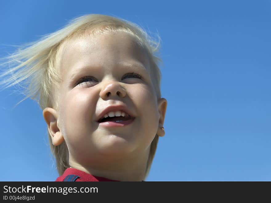 Laughing the boy. The two-year-old blue-eyed blonde.