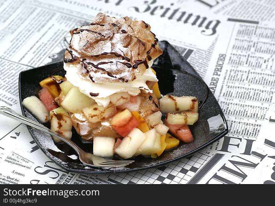 Puff on black dish, standing on newspaper table. Puff on black dish, standing on newspaper table.