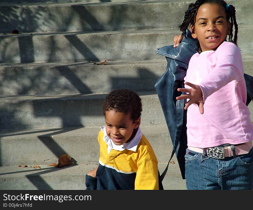 Boy and Girl running down the steps in the Fall. Boy and Girl running down the steps in the Fall.