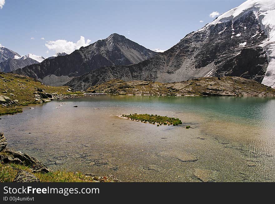 Small isle in the middle small lake. Small isle in the middle small lake