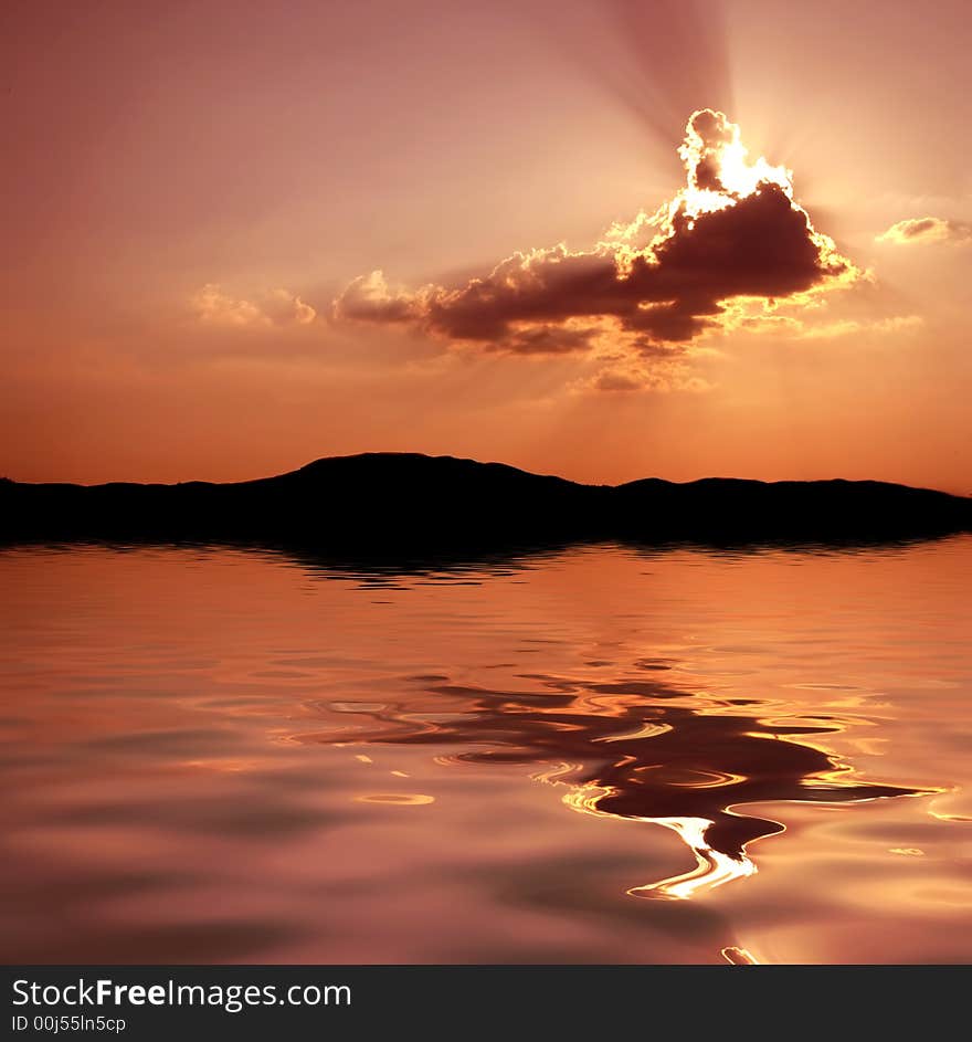 Island with clouds and sun-rays