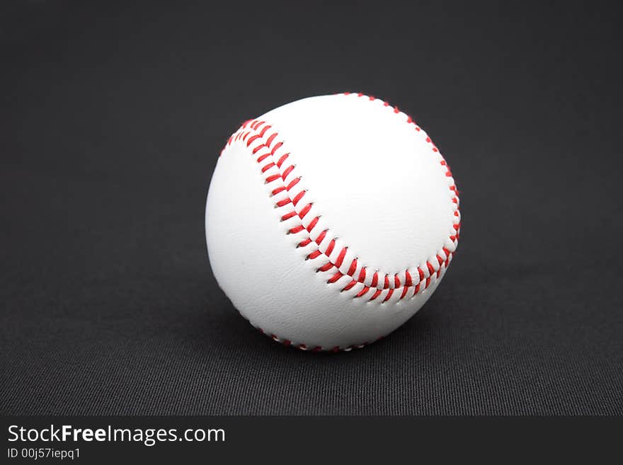 On a black background a baseball ball