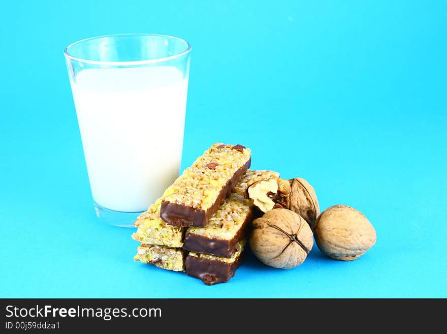 Pouring white milk against blue background and glass. Pouring white milk against blue background and glass