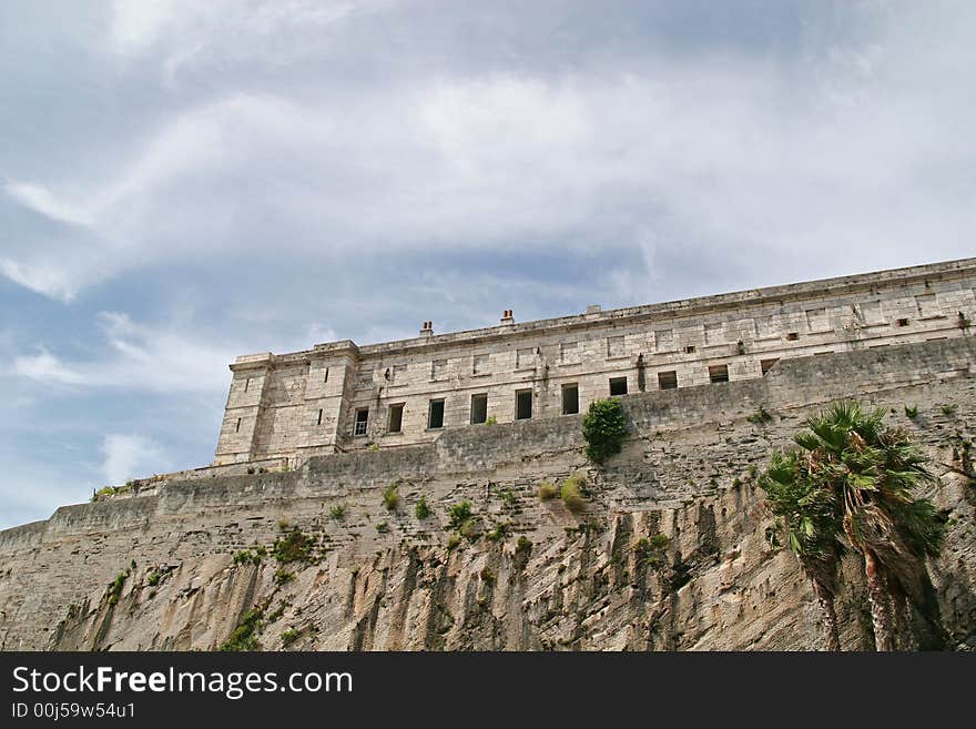 An old abandoned prison on a cliff against the sky. An old abandoned prison on a cliff against the sky