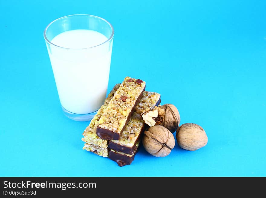 Pouring white milk against blue background and glass. Pouring white milk against blue background and glass