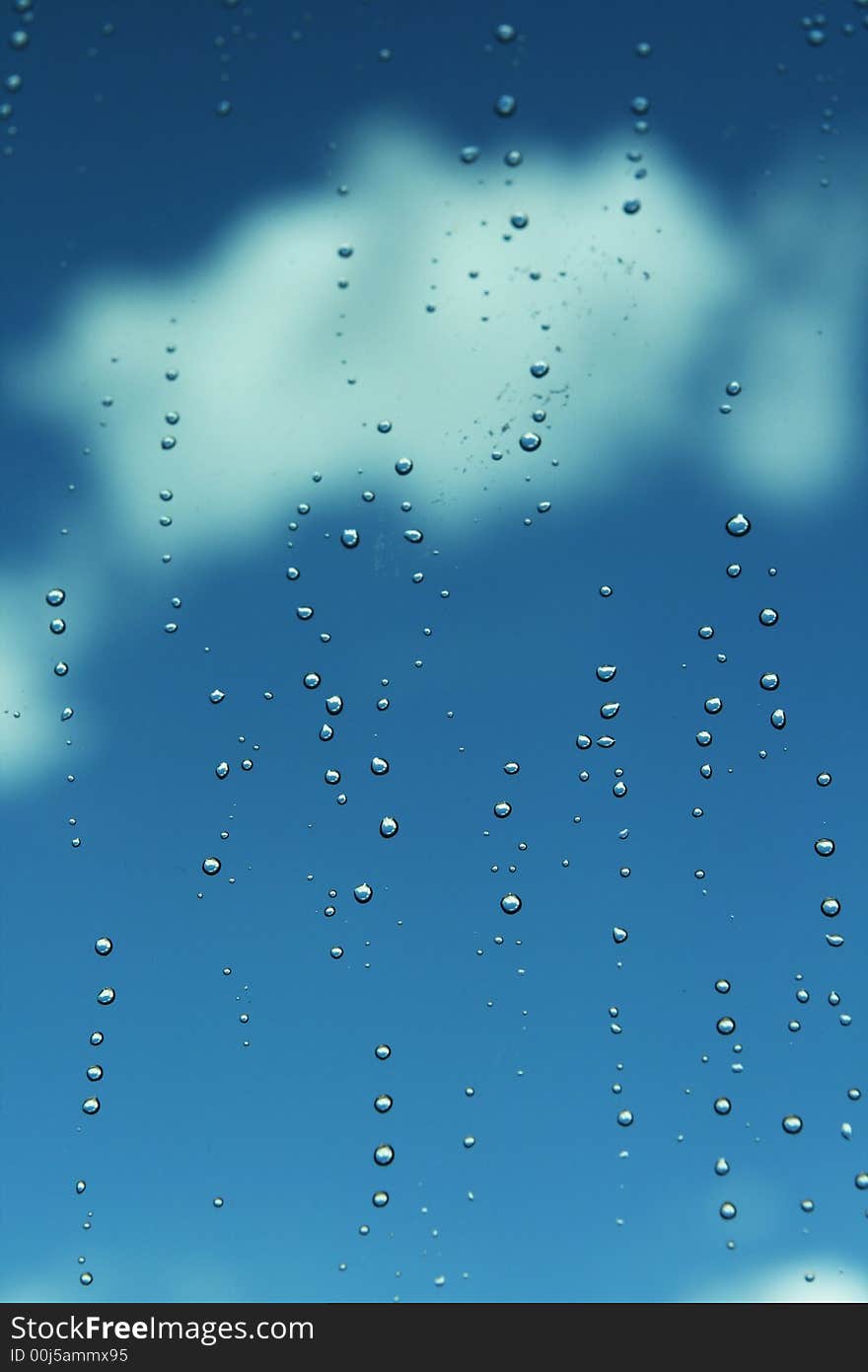 Rainwater drops under the background of blue sky. Rainwater drops under the background of blue sky.