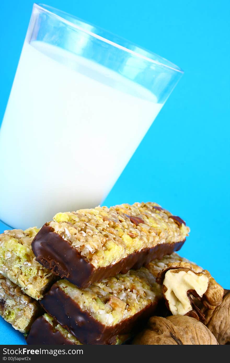 Pouring white milk against blue background and glass. Pouring white milk against blue background and glass