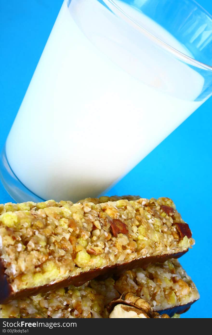 Pouring white milk against blue background and glass. Pouring white milk against blue background and glass