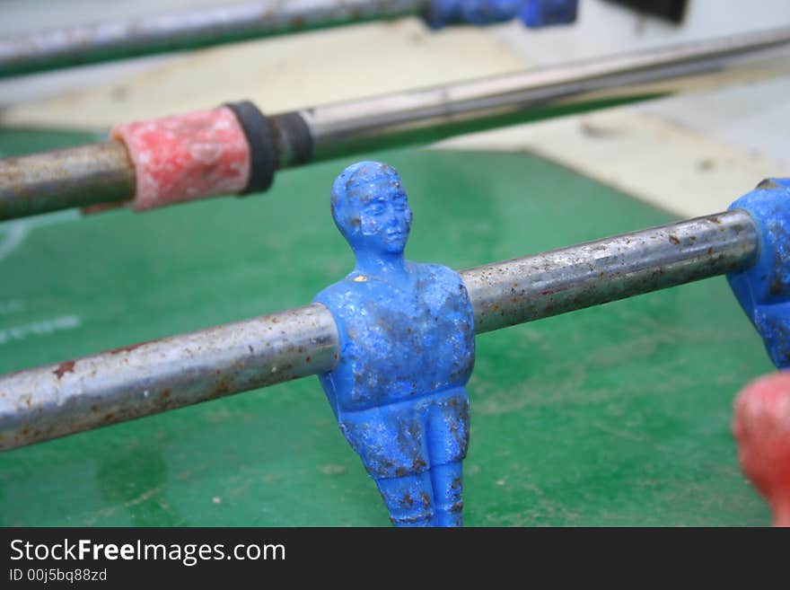 Closeup of a blue player in an old table football. Closeup of a blue player in an old table football