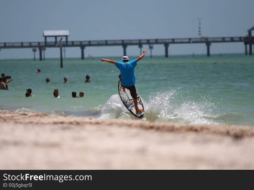 Guy try to jump on the sailboard. Guy try to jump on the sailboard