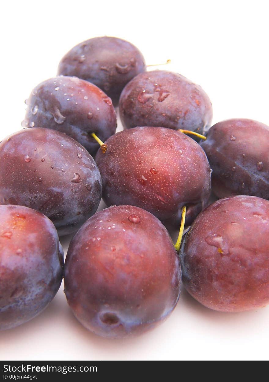 Fresh plums isolated over white background