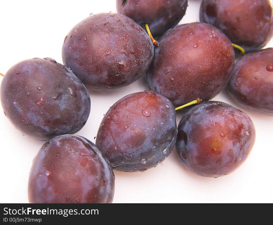 Fresh plums isolated over white background