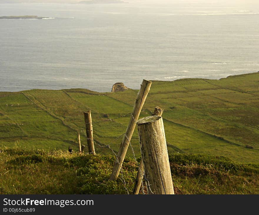 Farmland rolls out and down to the sea off Sky Road in Clifden, Ireland. Farmland rolls out and down to the sea off Sky Road in Clifden, Ireland