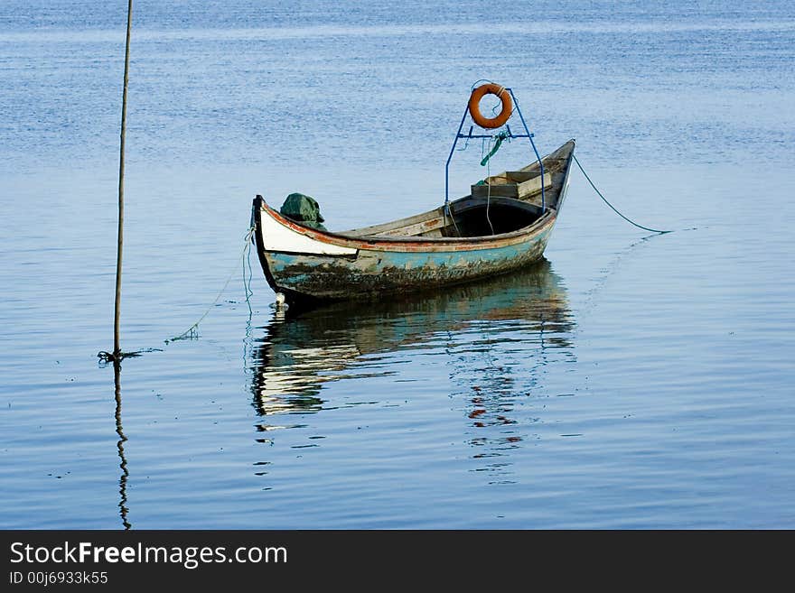 Old fishing boat with reflexion in water