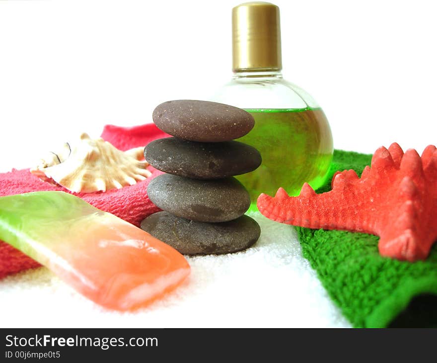 Spa essentials (pyramid of stones with towels, soap, seashell and shampoo)