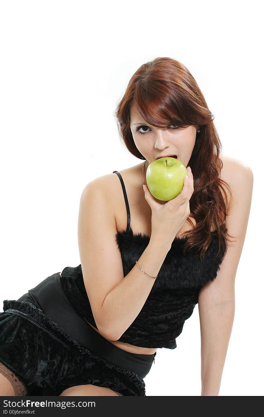 The beautiful girl eats a green apple. The beautiful girl eats a green apple