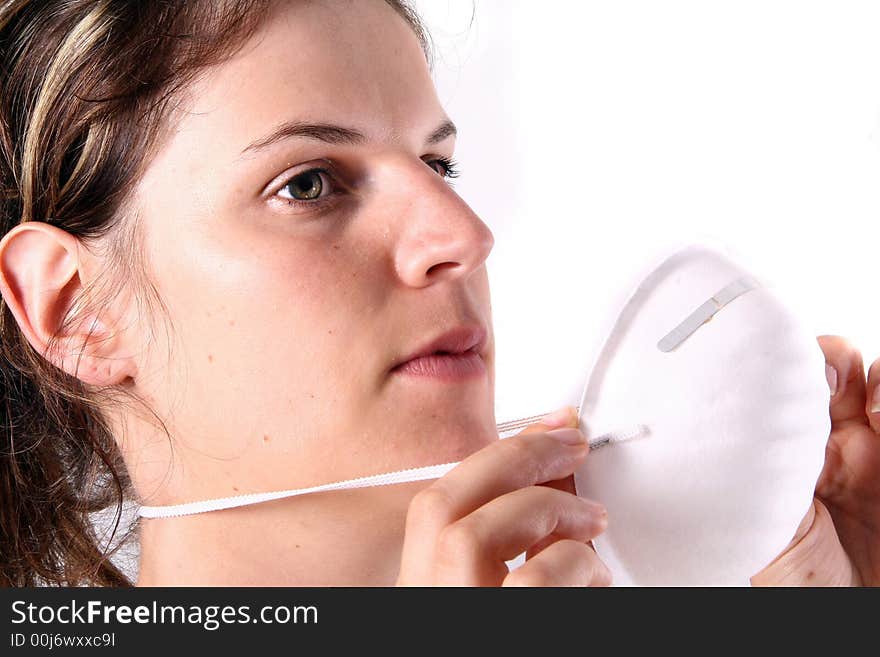 A young female doctor puts on her face mask!