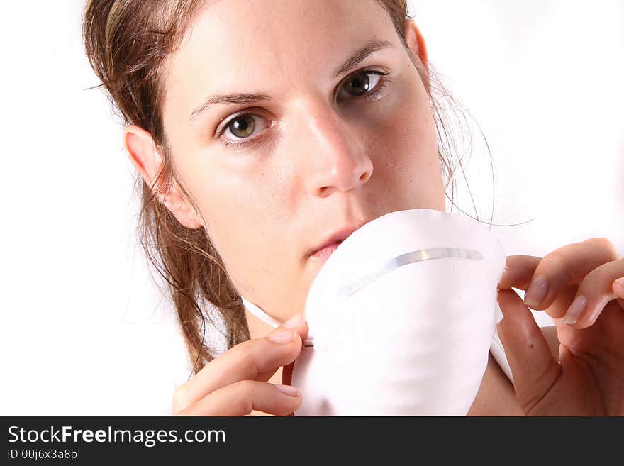 A young female doctor puts on her face mask. A young female doctor puts on her face mask.