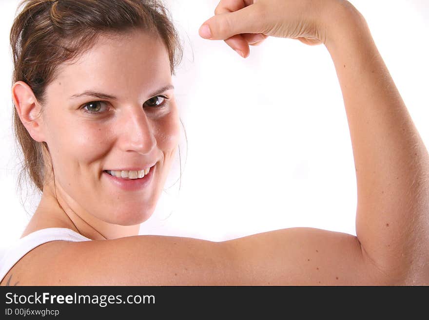 A pretty young woman flexing her biceps. A pretty young woman flexing her biceps.