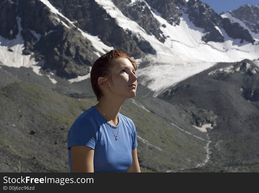 Dreaming girl with mountains as a background. Dreaming girl with mountains as a background