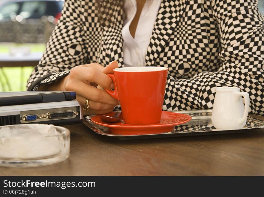 Image of a businesswoman enjoying a coffee break.