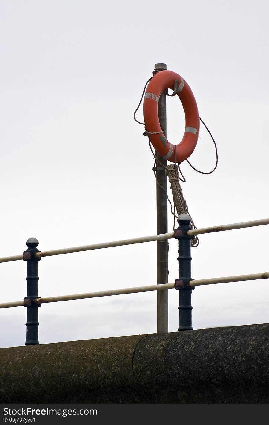 A lifebouy or lifesaving ring on a stand at the harbour. A lifebouy or lifesaving ring on a stand at the harbour