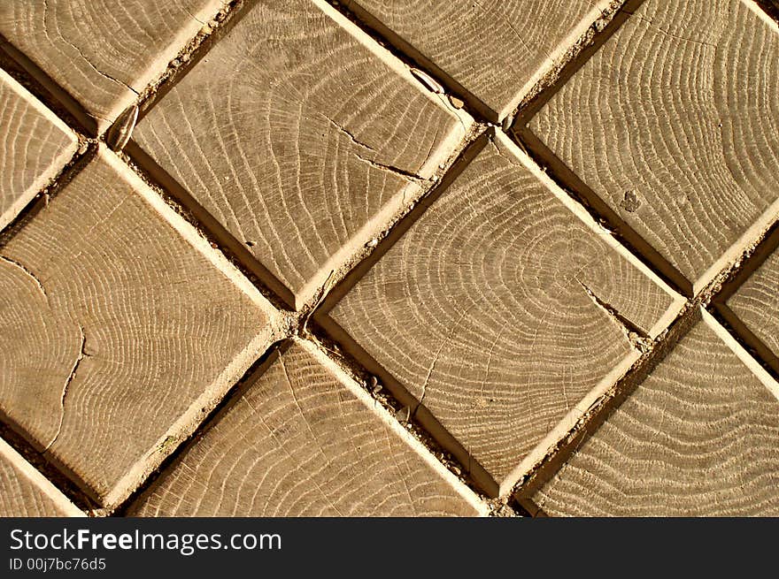 Square wooden bricks on a road