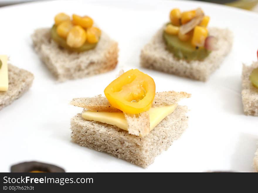 Fruit and vegetable canapes arranged as a face on a small plate. Fruit and vegetable canapes arranged as a face on a small plate