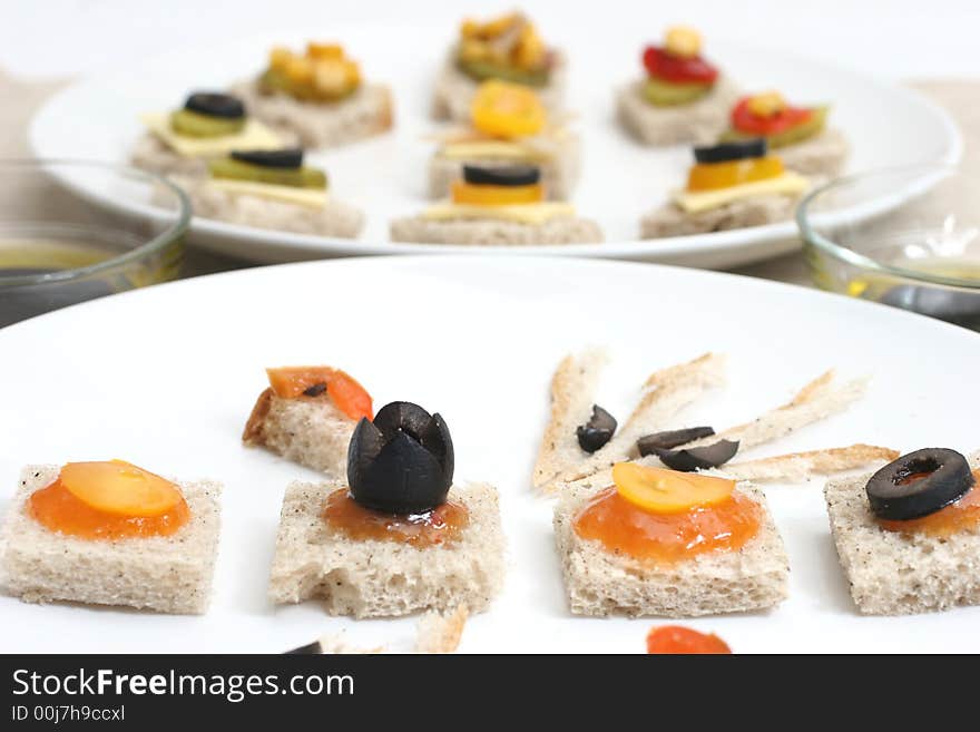 Fruit and vegetable canapes on a white ceramic plate. Fruit and vegetable canapes on a white ceramic plate