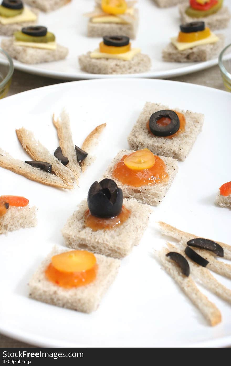 Fruit and vegetable canapes on a white ceramic plate. Fruit and vegetable canapes on a white ceramic plate