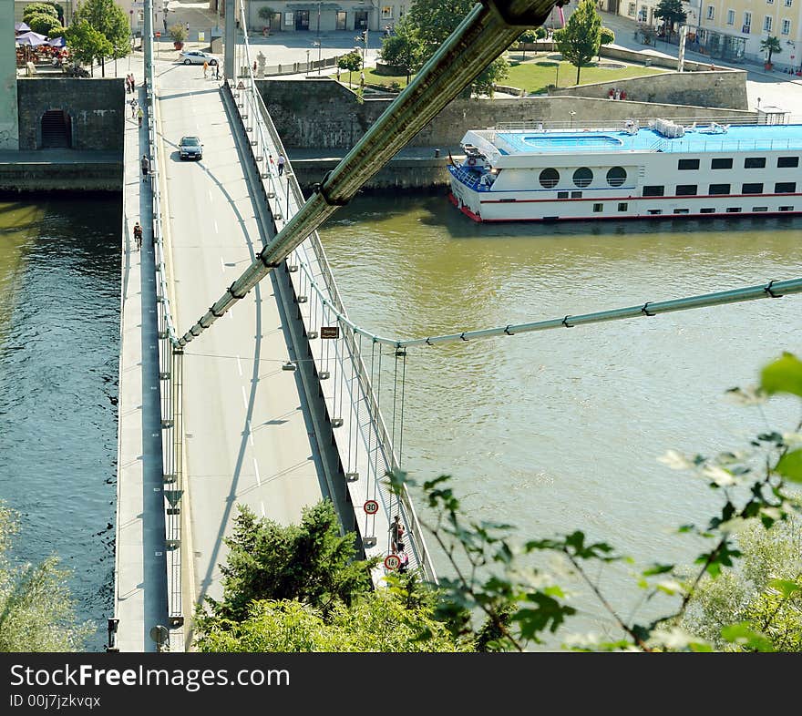 Hanged Bridge in Passau , historycal city in Bavaria, Germany . Donau river and part of white ship. August 2007.