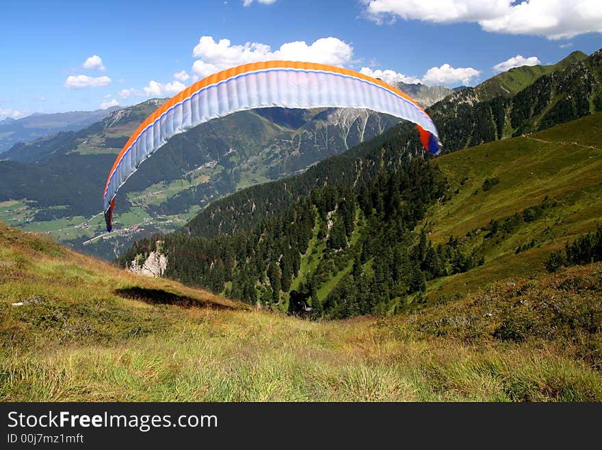 Image of a paraglider starting from mountain in Austrian Tirol. Image of a paraglider starting from mountain in Austrian Tirol