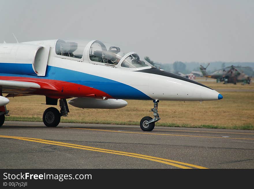 Military airplane parked on the airport waiting for the permission to fly.