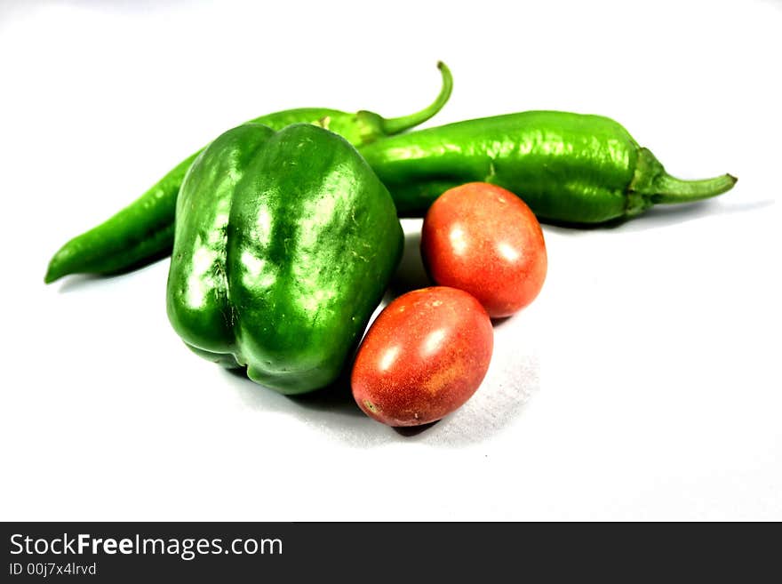 Green bell pepper, tomatoes and hot peppers to make salsa. Green bell pepper, tomatoes and hot peppers to make salsa