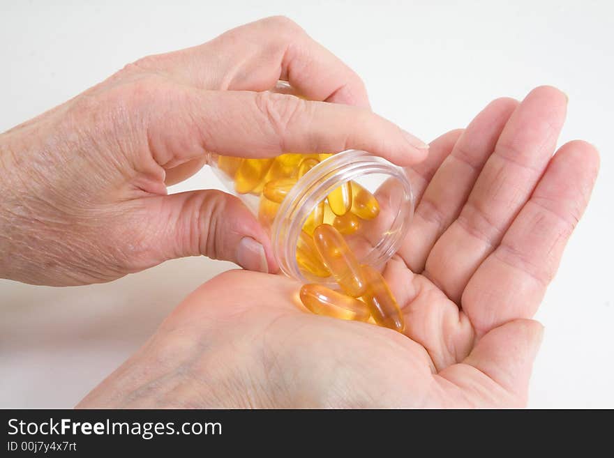 Close-up on pills being poured in a hand. Close-up on pills being poured in a hand