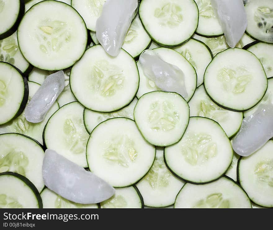 Fresh, cool cucumbers! Pile of freshly sliced cucumbers, tossed with ice cubs.