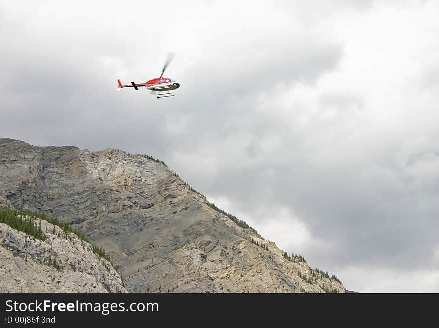 Helicopter flying over the mountains with overcast sky. Helicopter flying over the mountains with overcast sky.