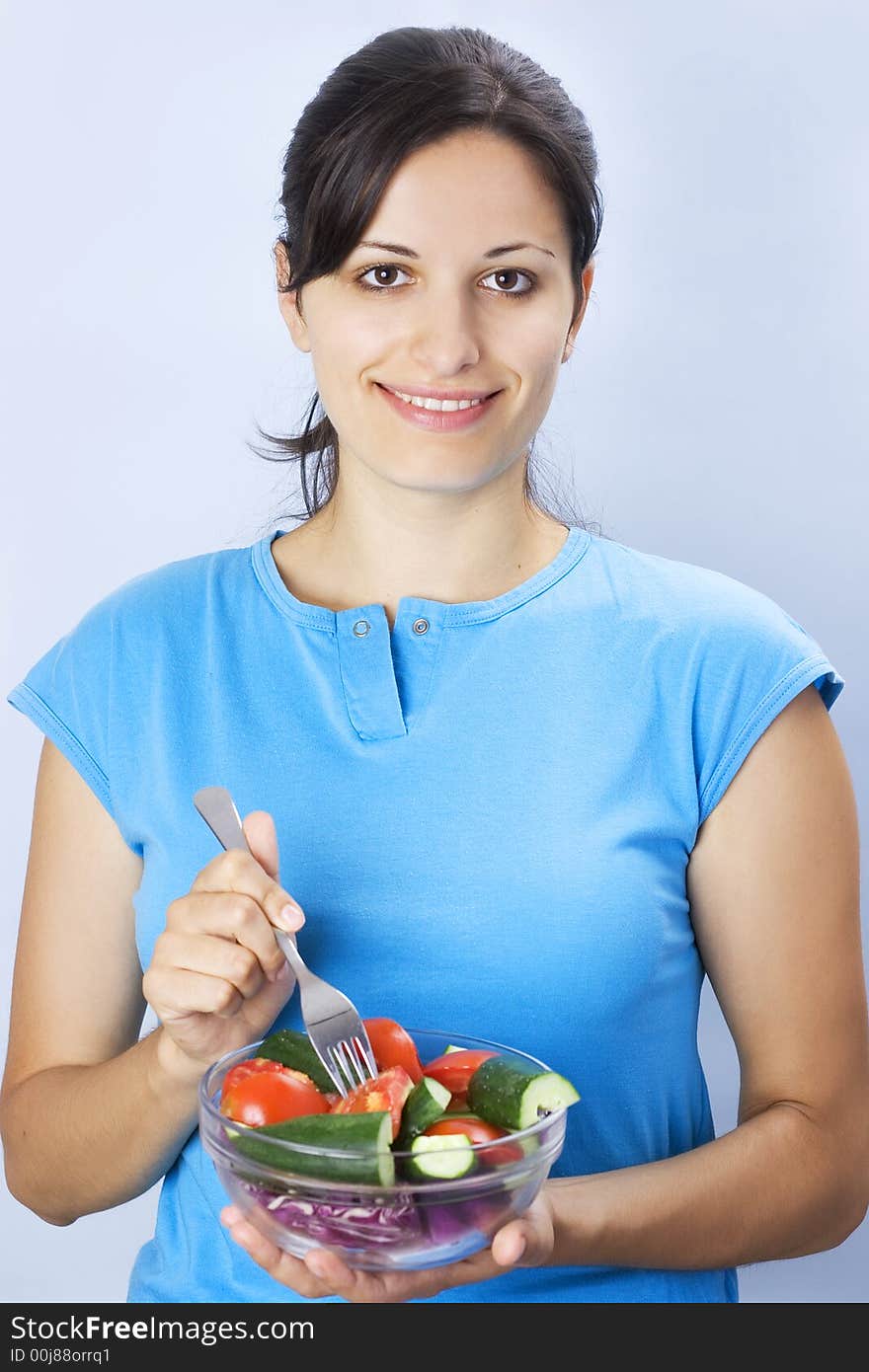 Beautiful young girl holding plate with salad. Beautiful young girl holding plate with salad