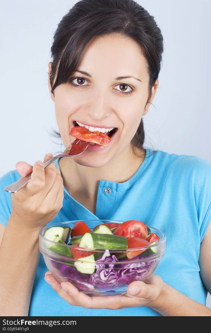 Beautiful young girl holding plate with salad. Beautiful young girl holding plate with salad