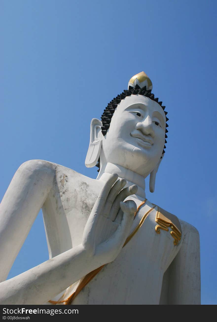 Buddhist statue from Thailand against a blue sky - travel and tourism.