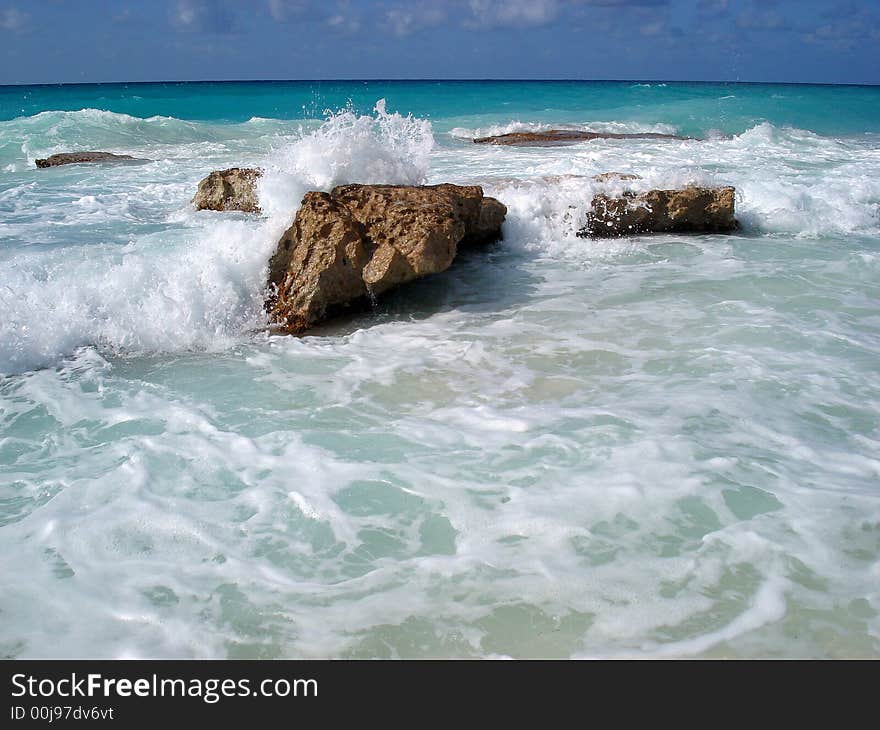 Wave splashing rocks