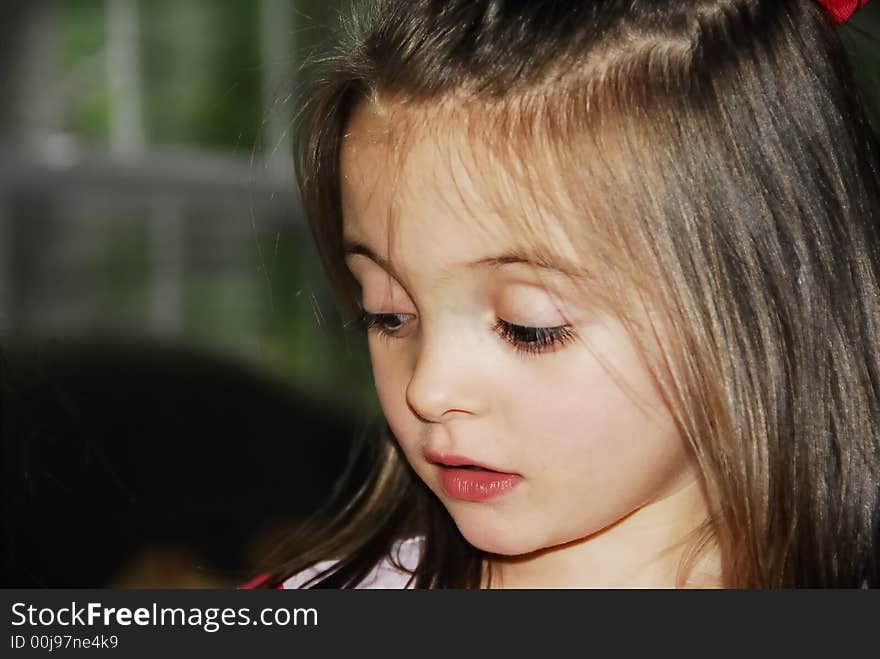 Beautiful girl looking really cute with a very expressive expression on her face while looking down.