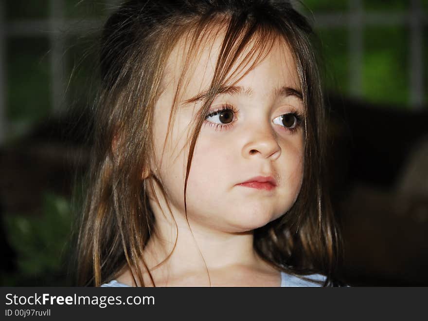 Beautiful close-up of a Brunette with her hair all over her face and huge brown eyes with long eyelashes. Beautiful close-up of a Brunette with her hair all over her face and huge brown eyes with long eyelashes.