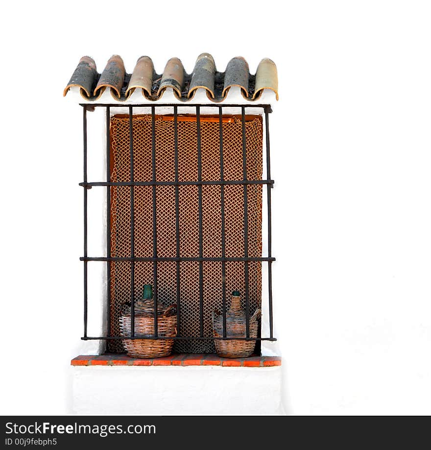 Unusual ornate window with bottles into baskets