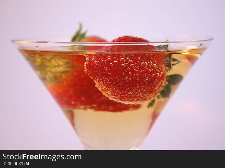 Strawberries in a glass of sparkling apple juice. Strawberries in a glass of sparkling apple juice