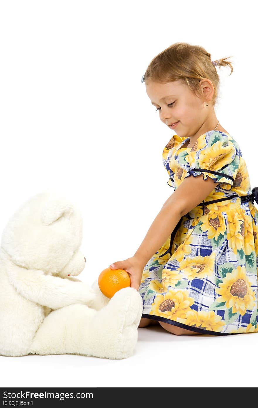 Little girl with orange and bear toy. Isolate on white background.